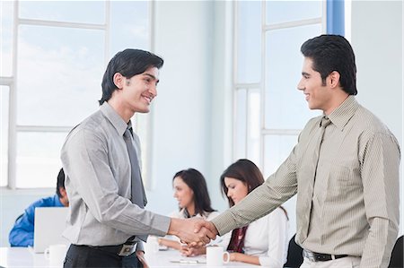 Two businessmen shaking hands in a meeting Stock Photo - Premium Royalty-Free, Code: 630-06722361