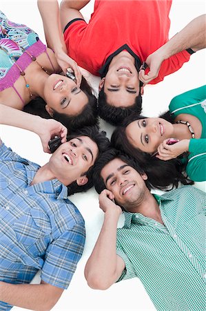 south asian teen - High angle view of friends talking on mobile phones Stock Photo - Premium Royalty-Free, Code: 630-06722465