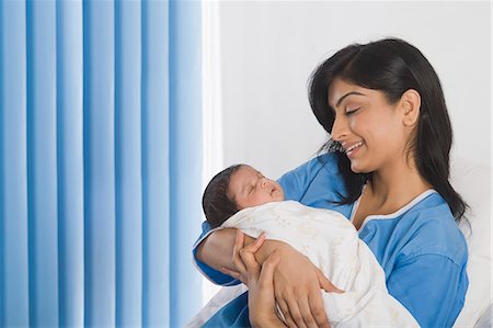photos of mom carrying a new born baby - Woman carrying her baby and smiling Stock Photo - Premium Royalty-Free, Code: 630-06722555