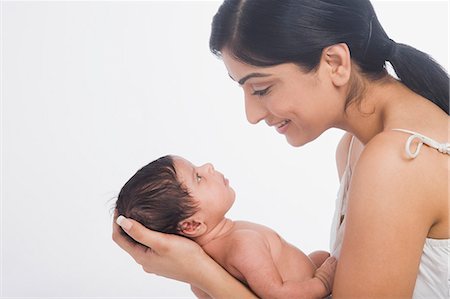 ethnic baby hands - Woman carrying her baby and smiling Stock Photo - Premium Royalty-Free, Code: 630-06722577