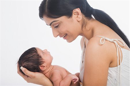 photos of mom carrying a new born baby - Woman carrying her baby and smiling Stock Photo - Premium Royalty-Free, Code: 630-06722578