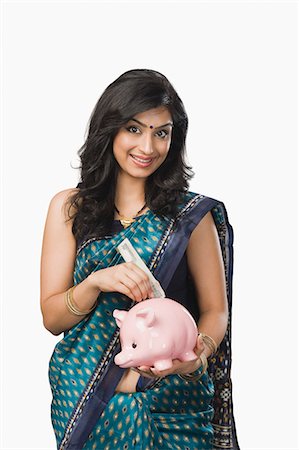 Woman inserting money into a piggybank Foto de stock - Sin royalties Premium, Código: 630-06722608