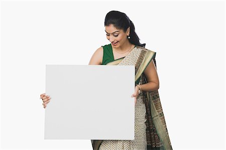 Woman holding a whiteboard and smiling Fotografie stock - Premium Royalty-Free, Codice: 630-06722616