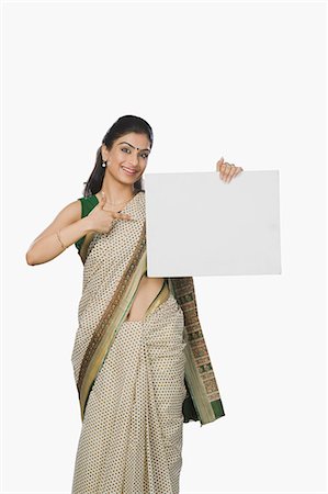 Woman pointing at a whiteboard and smiling Stock Photo - Premium Royalty-Free, Code: 630-06722618