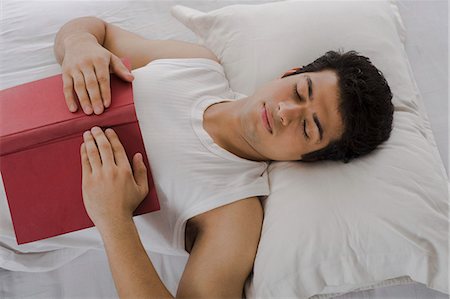 simsearch:6108-06166252,k - University student sleeping with a book on the bed Photographie de stock - Premium Libres de Droits, Code: 630-06722662