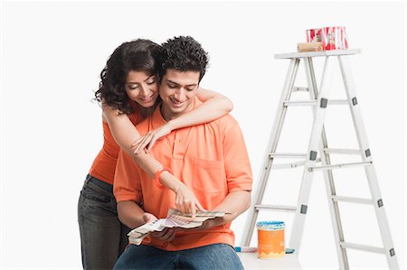 Couple choosing color from color swatches for their house Stock Photo - Premium Royalty-Free, Code: 630-06722735