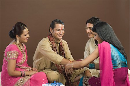 Woman tying rakhi on the wrist of her brother Stock Photo - Premium Royalty-Free, Code: 630-06722848