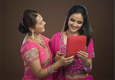 saree indian moms - Woman giving a present to her daughter Stock Photo - Premium Royalty-Free, Code: 630-06722869