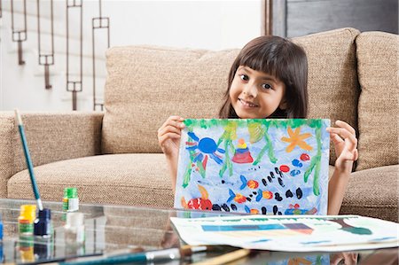 Portrait of a girl showing a painting Stock Photo - Premium Royalty-Free, Code: 630-06722975