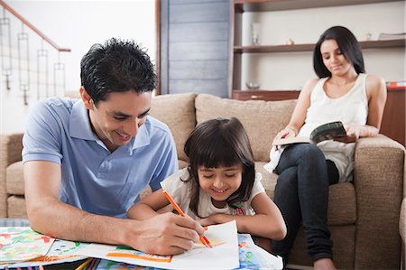 people in india home - Man assisting his daughter in drawing Stock Photo - Premium Royalty-Free, Code: 630-06722996