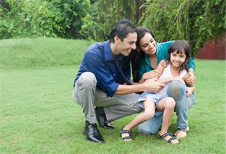 south asians family - Family enjoying in rain in a park Stock Photo - Premium Royalty-Free, Code: 630-06723063