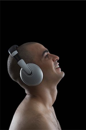 simsearch:6108-08725387,k - Close-up of a man listening to headphones Stock Photo - Premium Royalty-Free, Code: 630-06723145