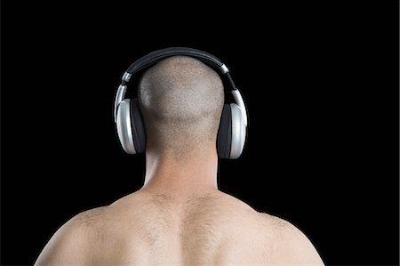 simsearch:6108-08725387,k - Rear view of a man listening to headphones Stock Photo - Premium Royalty-Free, Code: 630-06723147