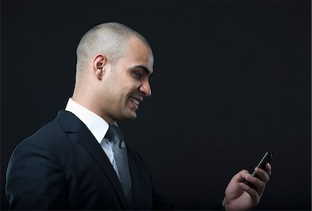 simsearch:630-06723241,k - Businessman text messaging on a mobile phone Stock Photo - Premium Royalty-Free, Code: 630-06723179