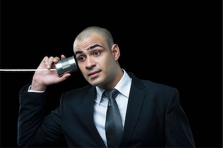 simsearch:630-06723241,k - Businessman using tin can phone Stock Photo - Premium Royalty-Free, Code: 630-06723185