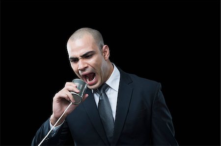 Businessman shouting on a tin can phone Foto de stock - Sin royalties Premium, Código: 630-06723187