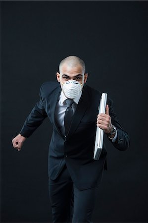 simsearch:630-06723232,k - Portrait of a businessman wearing a pollution mask and running Stock Photo - Premium Royalty-Free, Code: 630-06723183