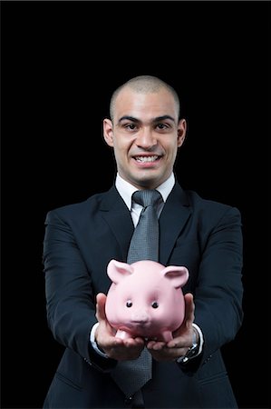 simsearch:630-06722067,k - Portrait of a businessman holding a piggy bank Photographie de stock - Premium Libres de Droits, Code: 630-06723209