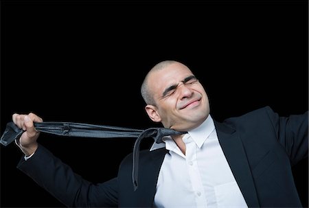 suicide - Businessman hanging himself with his tie Stock Photo - Premium Royalty-Free, Code: 630-06723211