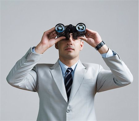 simsearch:630-06723232,k - Businessman looking through binoculars Stock Photo - Premium Royalty-Free, Code: 630-06723229