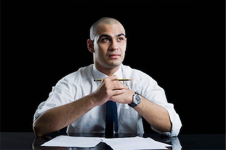 simsearch:630-06723241,k - Businessman sitting at a table and thinking Stock Photo - Premium Royalty-Free, Code: 630-06723254