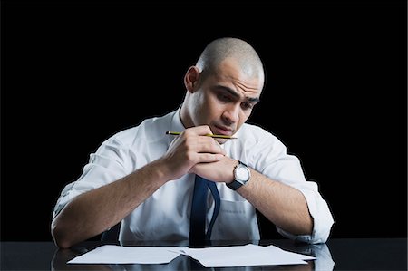 simsearch:630-06723241,k - Businessman sitting at a table and thinking Stock Photo - Premium Royalty-Free, Code: 630-06723255
