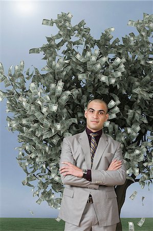 Businessman standing in front of a money tree Fotografie stock - Premium Royalty-Free, Codice: 630-06723259