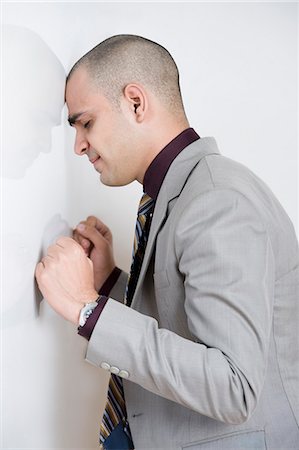 simsearch:630-06723232,k - Businessman leaning his head against a wall Stock Photo - Premium Royalty-Free, Code: 630-06723266