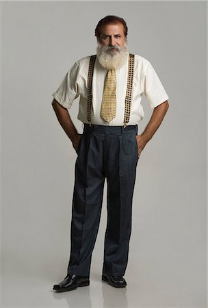 suspenders (straps worn over shoulders) - Portrait of a man standing with his hands in his pockets Stock Photo - Premium Royalty-Free, Code: 630-06723278