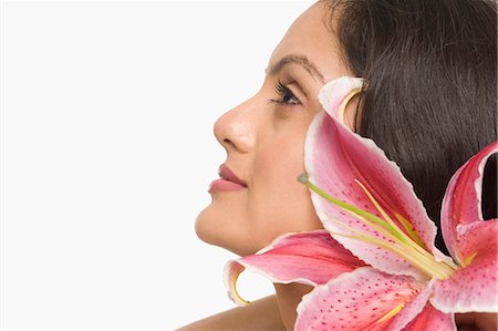 simsearch:630-06721875,k - Close-up of a woman with Tiger Lily flower Photographie de stock - Premium Libres de Droits, Code: 630-06723344