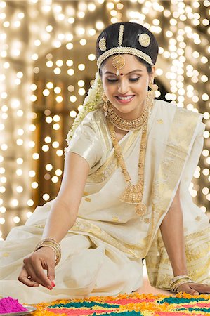 saari - Indian woman in traditional clothing making rangoli at Durga festival Stock Photo - Premium Royalty-Free, Code: 630-06723365