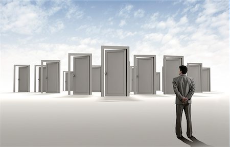 suit man standing backside - Businessman standing in front of doors Stock Photo - Premium Royalty-Free, Code: 630-06723510