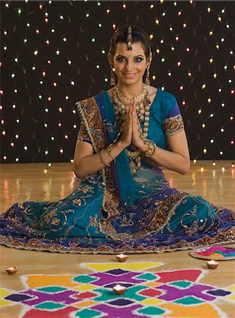 diwali lights photography - Woman greeting in prayer position near rangoli at Diwali festival Stock Photo - Premium Royalty-Free, Code: 630-06723546