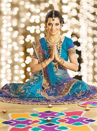 religion sign - Woman greeting in prayer position near rangoli at Diwali festival Stock Photo - Premium Royalty-Free, Code: 630-06723559