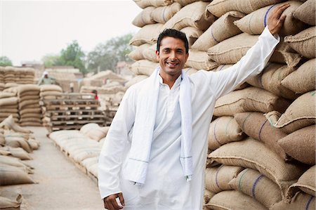 Man standing near stacks of wheat sacks in a warehouse, Anaj Mandi, Sohna, Gurgaon, Haryana, India Stock Photo - Premium Royalty-Free, Code: 630-07071170