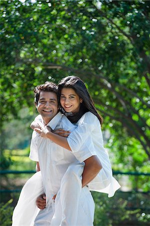 Man carried his girlfriend piggyback in a park, Japanese Park, Rohini, Delhi, India Stock Photo - Premium Royalty-Free, Code: 630-07071221