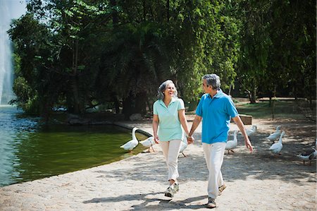 ethnic couple lifestyle not kids full length not eye contact - Mature couple walking in a park and smiling, Lodi Gardens, New Delhi, India Stock Photo - Premium Royalty-Free, Code: 630-07071249