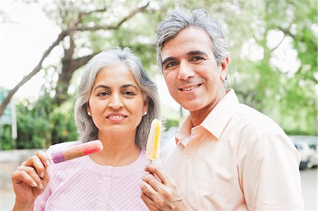 Mature couple eating ice cream candies, Lodi Gardens, New Delhi, India Stock Photo - Premium Royalty-Free, Code: 630-07071315