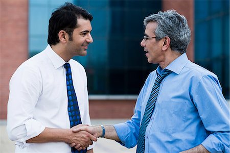 Businessman shaking hands with another businessman Stock Photo - Premium Royalty-Free, Code: 630-07071522