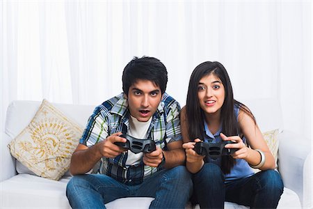 Brother and sister playing video game Stock Photo - Premium Royalty-Free, Code: 630-07071735