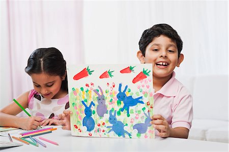 drawings of a girl and boy - Children making drawings with colored pencils Stock Photo - Premium Royalty-Free, Code: 630-07071754