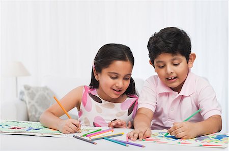 sister brother indian - Children making drawings with colored pencils Stock Photo - Premium Royalty-Free, Code: 630-07071755