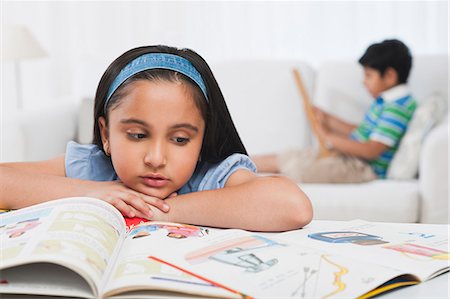 simsearch:649-07280848,k - Girl reading books with her brother in the background Photographie de stock - Premium Libres de Droits, Code: 630-07071756