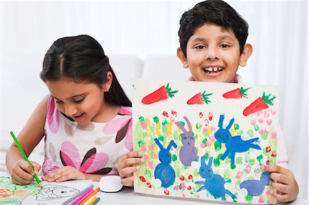 drawings of a girl and boy - Children making drawings with colored pencils Stock Photo - Premium Royalty-Free, Code: 630-07071753