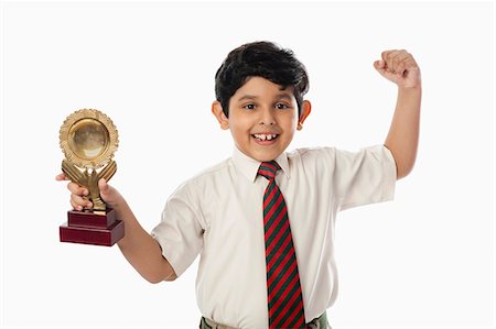 simsearch:693-06324793,k - Schoolboy holding a trophy Fotografie stock - Premium Royalty-Free, Codice: 630-07071789