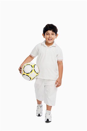 Boy holding a football Stock Photo - Premium Royalty-Free, Code: 630-07071808