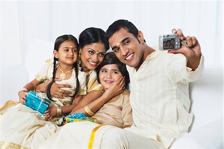 daughter dad selfie - South Indian man taking a picture of his family at Onam Stock Photo - Premium Royalty-Free, Code: 630-07071853