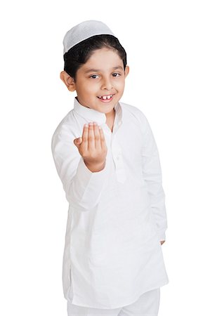 religion sign - Muslim boy greeting and smiling Stock Photo - Premium Royalty-Free, Code: 630-07071928