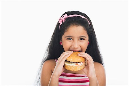 simsearch:630-07071928,k - Girl eating a burger Stock Photo - Premium Royalty-Free, Code: 630-07071930