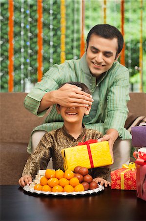diwali sweets with people - Man giving gift to his son on Diwali Stock Photo - Premium Royalty-Free, Code: 630-07071979